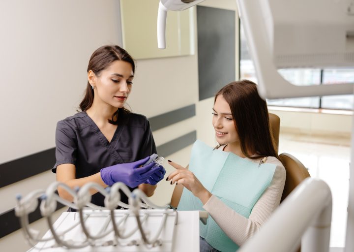 dentist-holding-transparent-aligners-for-teeth-correction-for-a-patient-in-dentistry-clinic.jpg dentist-holding-transparent-aligners-for-teeth-correction-for-a-patient-in-dentistry-clinic.jpg